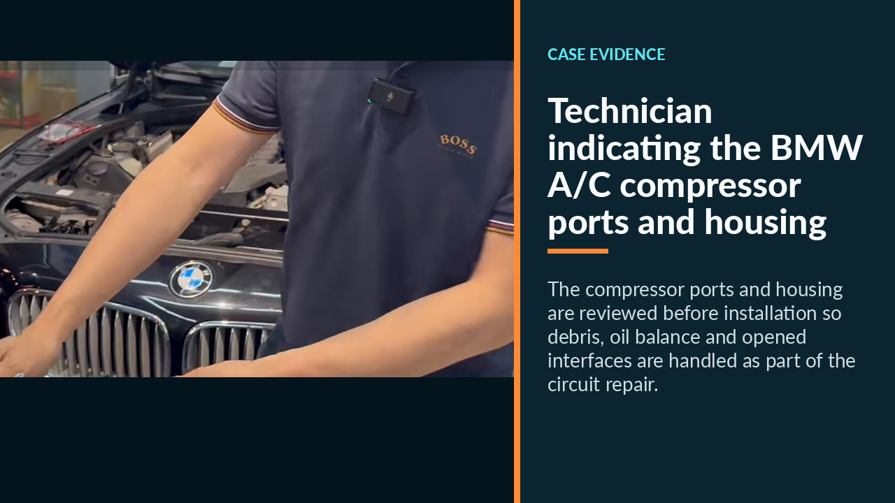 Technician indicating the BMW A/C compressor ports and housing