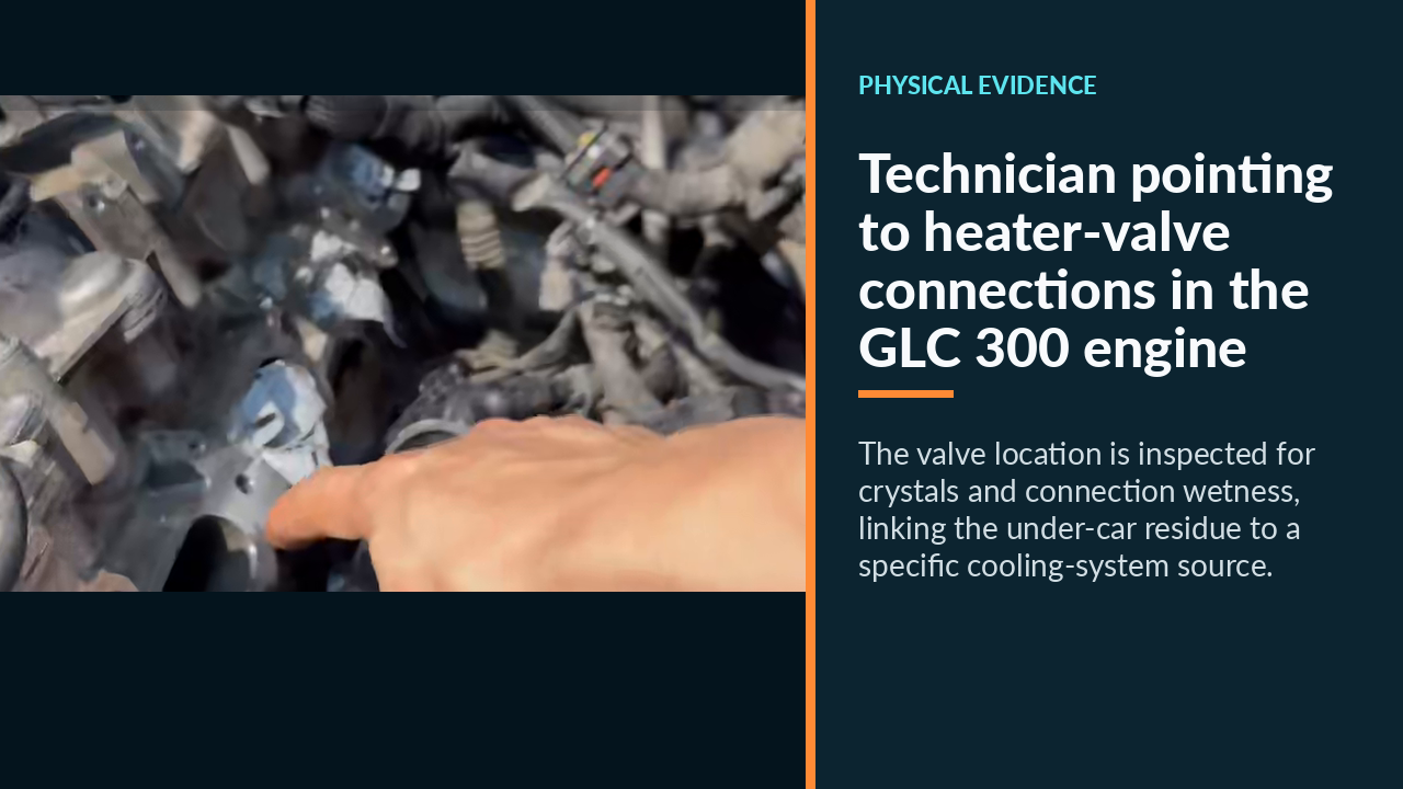 Technician pointing to heater-valve connections in the GLC 300 engine bay