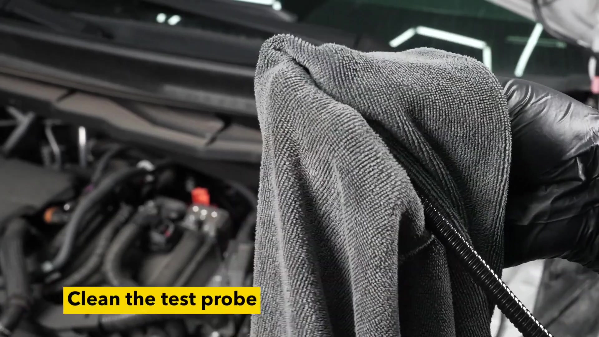 Operator wiping the AUTOOL AS502 probe clean before a brake fluid test