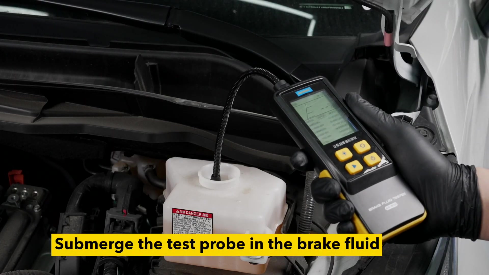 AUTOOL AS502 flexible probe placed into an open brake fluid reservoir