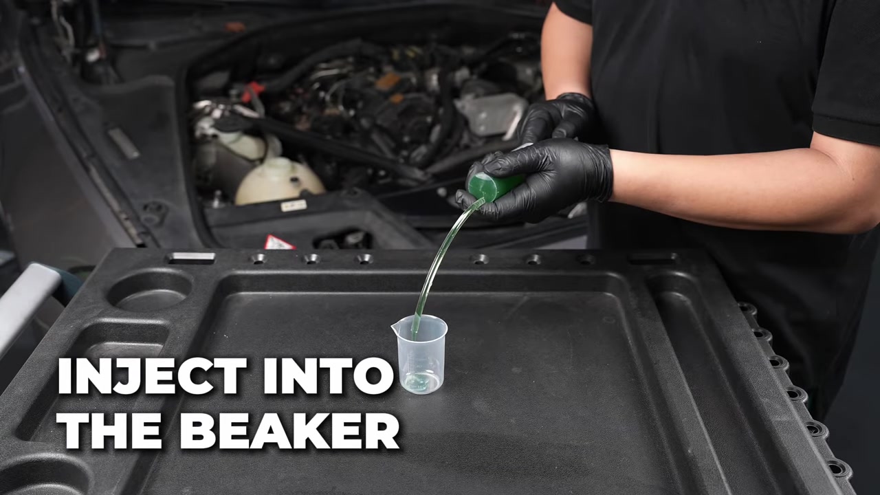 Identified coolant being transferred from a dedicated syringe into the AUTOOL AS509 beaker