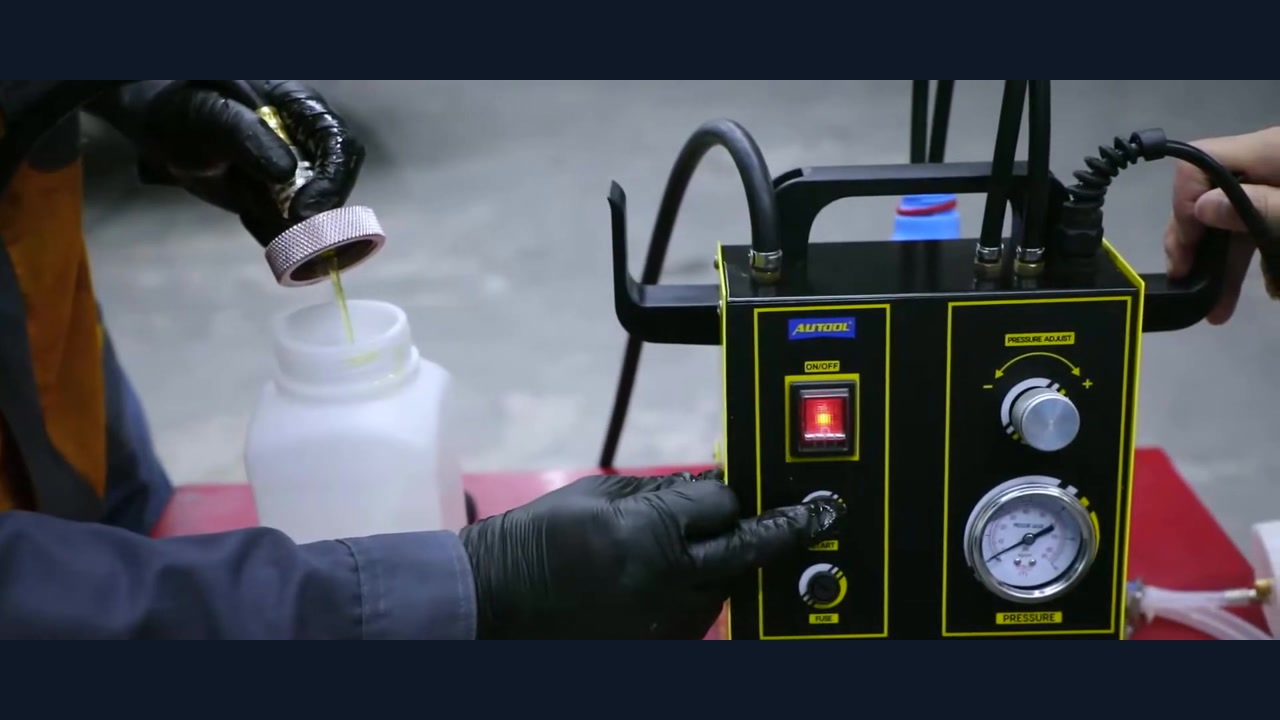AUTOOL AST605 filling path discharging into a controlled collector away from the vehicle.