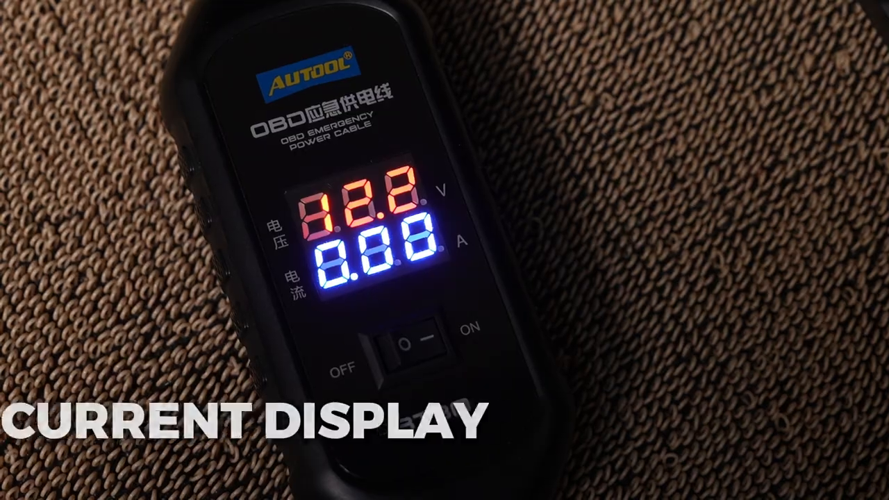 AUTOOL BT30 digital display showing voltage and current channels while the cable is in use.