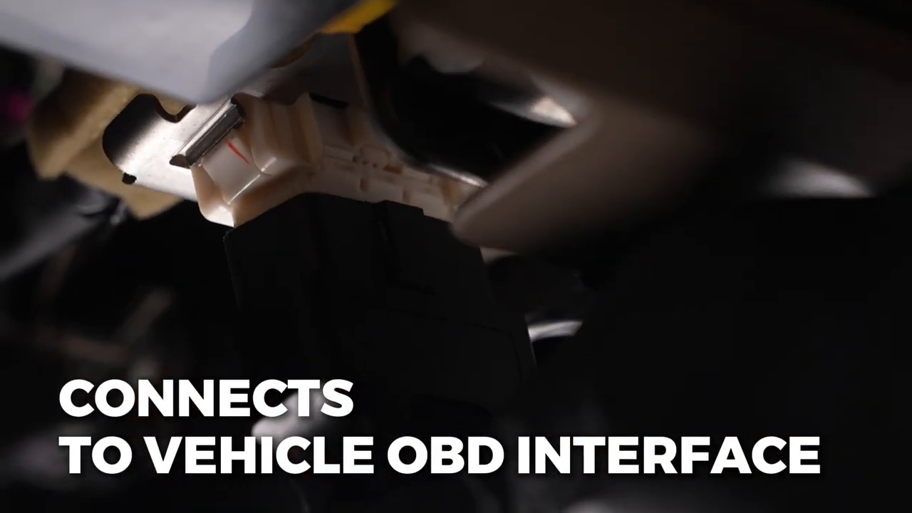 Gloved hands connecting the AUTOOL BT30 OBD plug to a vehicle diagnostic connector under the dashboard.