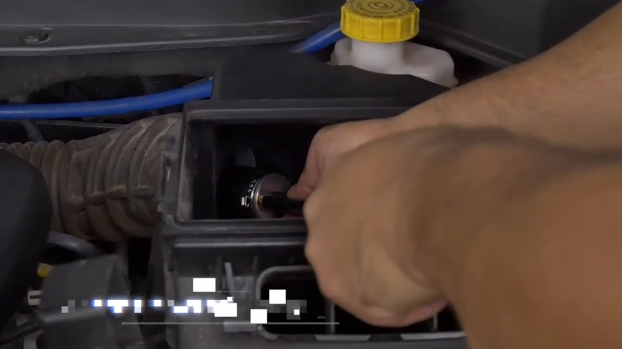 Technician guiding a deflated AUTOOL airbag-style adapter into an open intake duct.