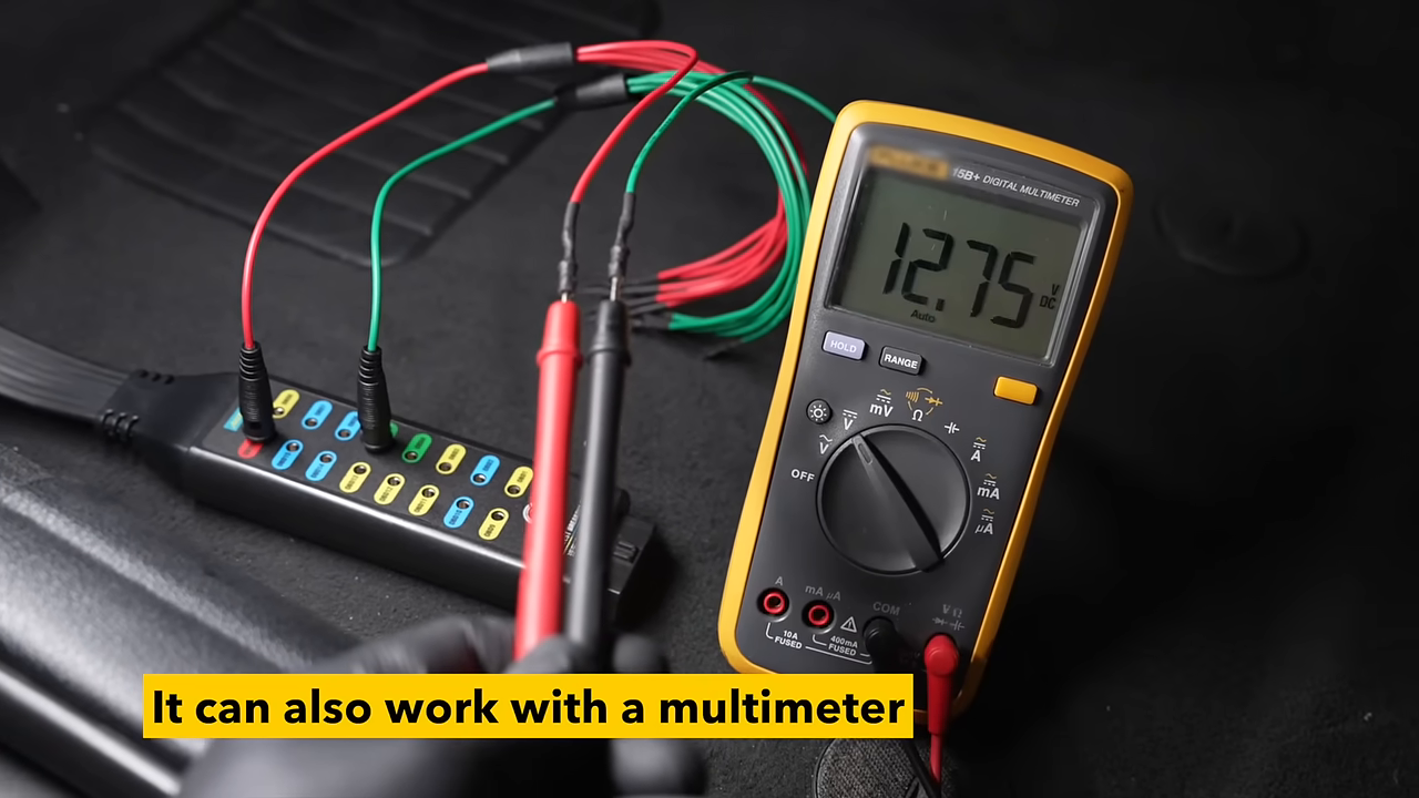 AUTOOL OBD2 Breakout Box Basic Version connected to a multimeter through one numbered jack.