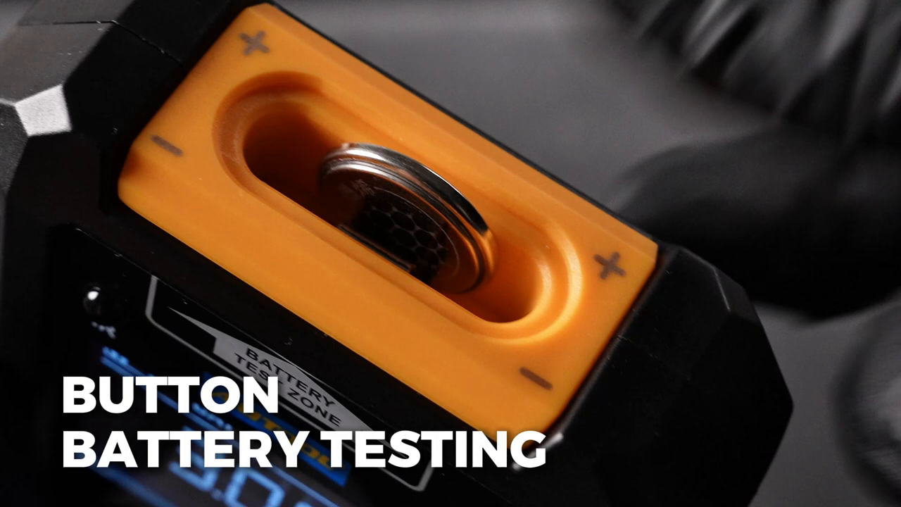 Supported remote-key button cell inserted into the AUTOOL RE110 BAT test area at the marked polarity.
