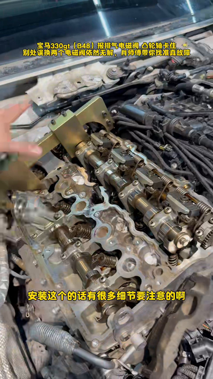 Exposed BMW B48 valvetrain with a timing fixture installed during repair
