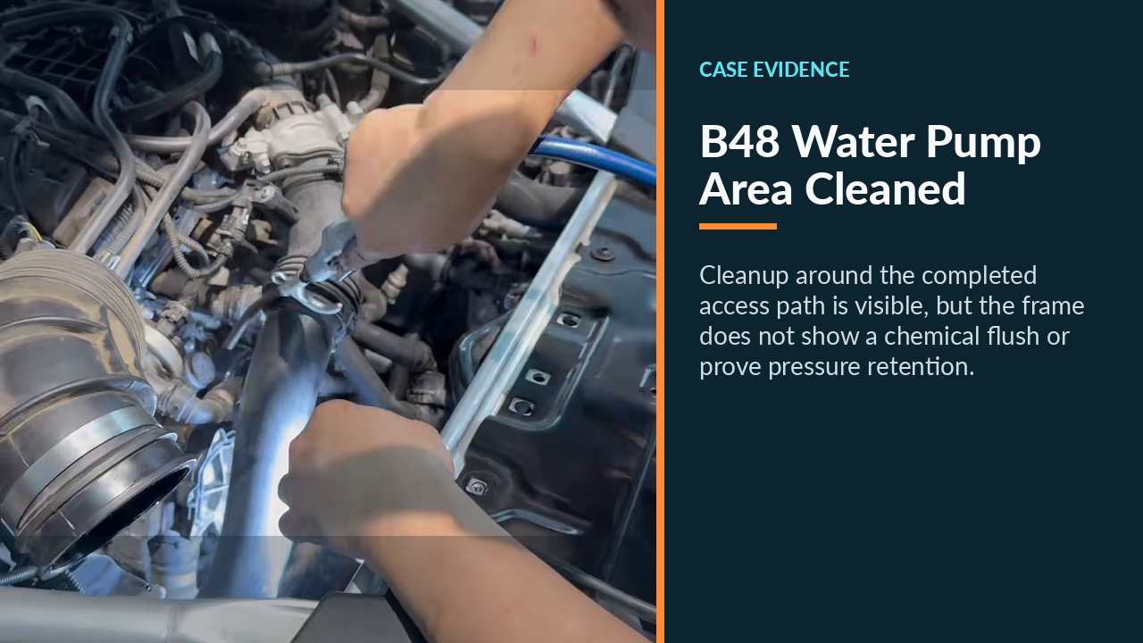 Technician cleaning the BMW B48 water-pump work area after installation.
