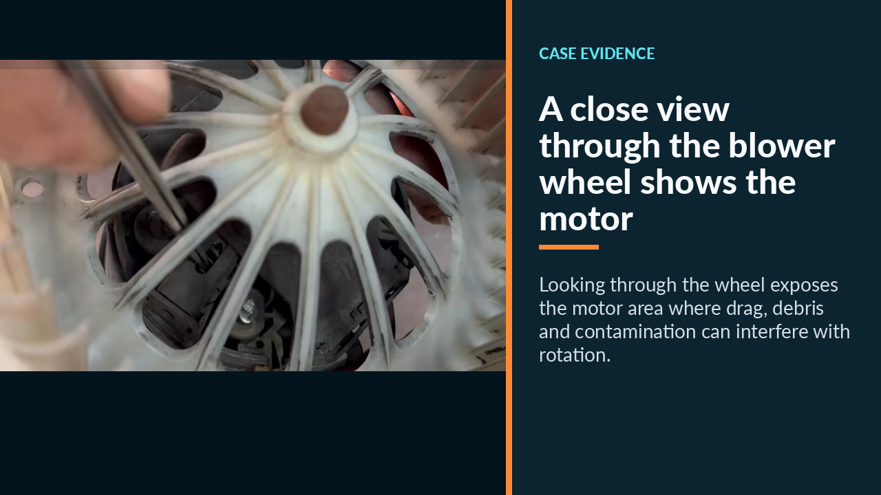 A close view through the blower wheel shows the motor area being inspected for mechanical drag and contamination.