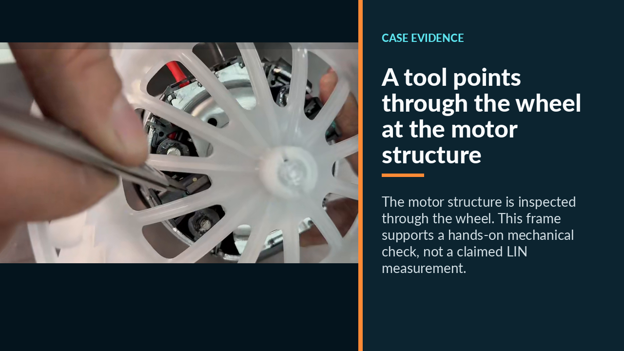 A tool points through the wheel at the motor structure