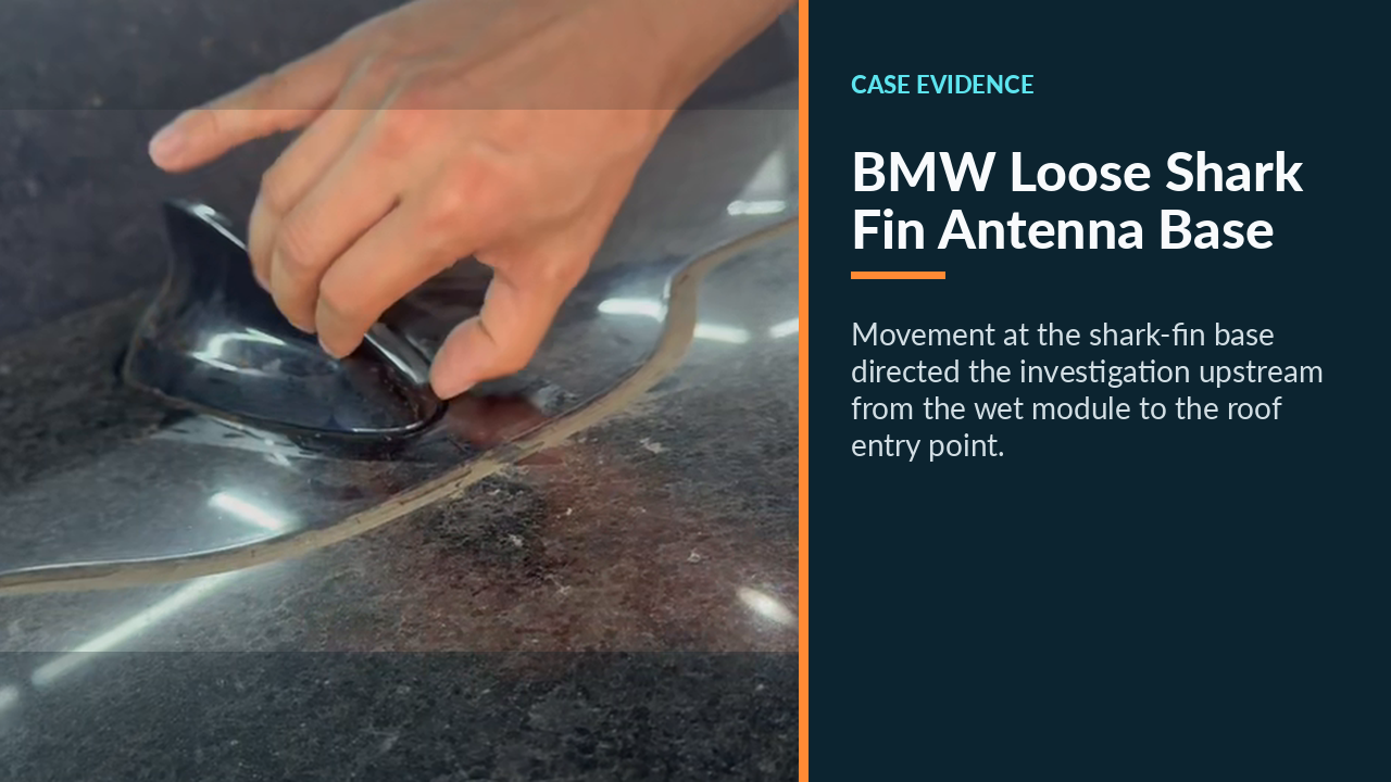 Hand moving the loose shark-fin antenna housing on the BMW roof.