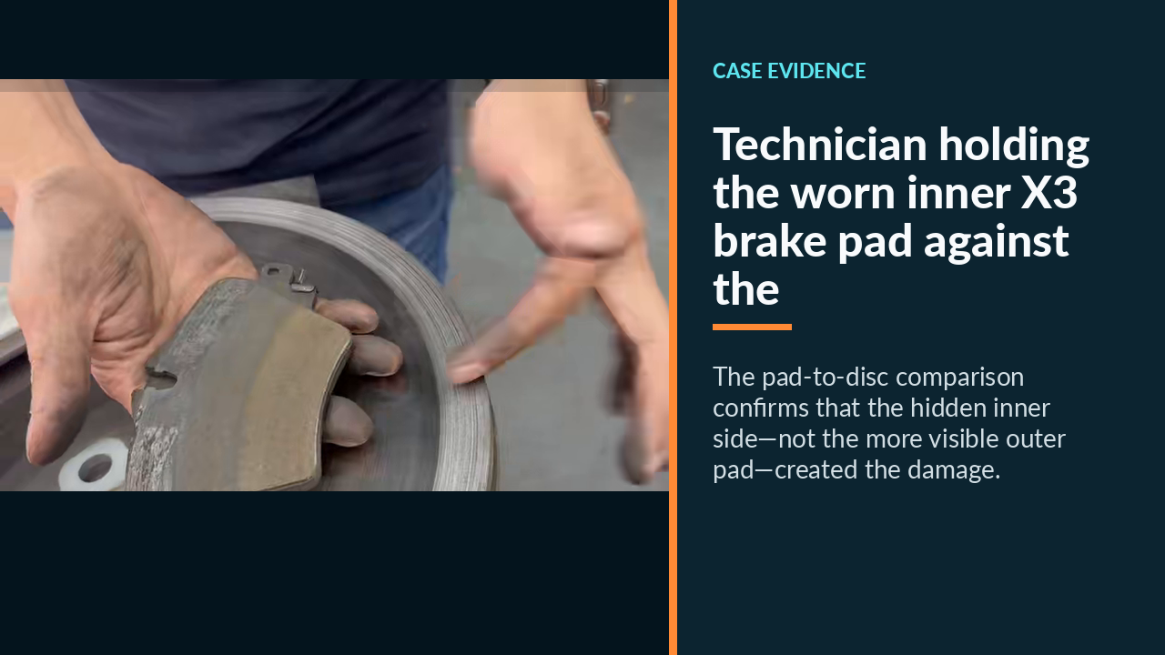 Technician holding the worn inner X3 brake pad against the damaged disc