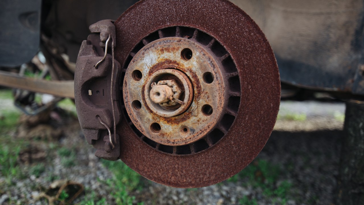 Exposed brake rotor and caliper with heavy surface corrosion