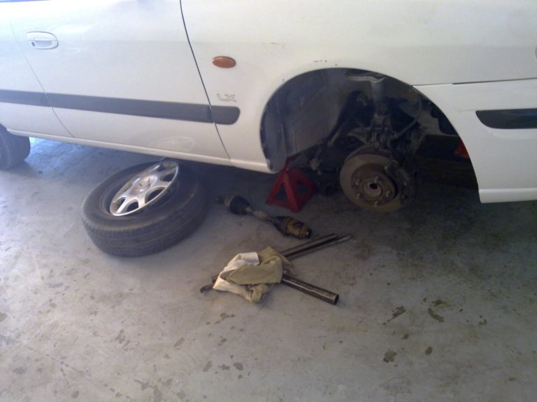 Car with the wheel removed, exposing the disc brake assembly
