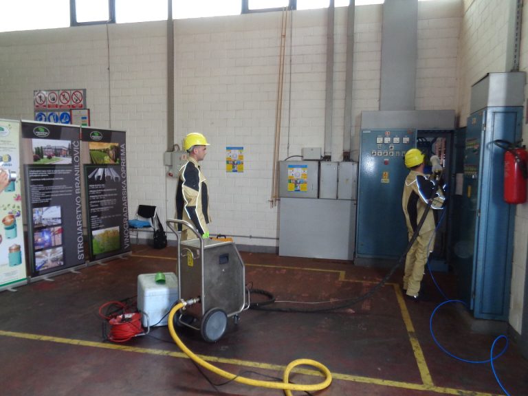 Operator using a dry ice blasting machine for industrial cleaning