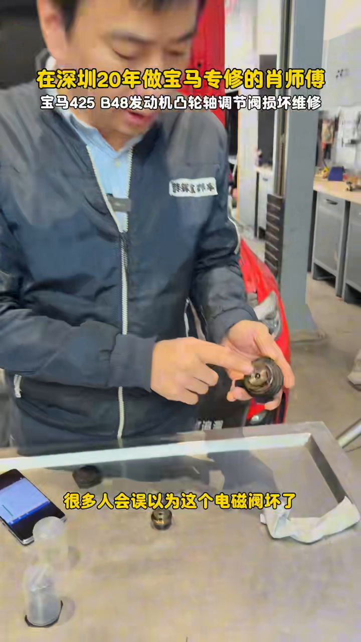 Technician cleaning a removed VANOS valve at 30 seconds
