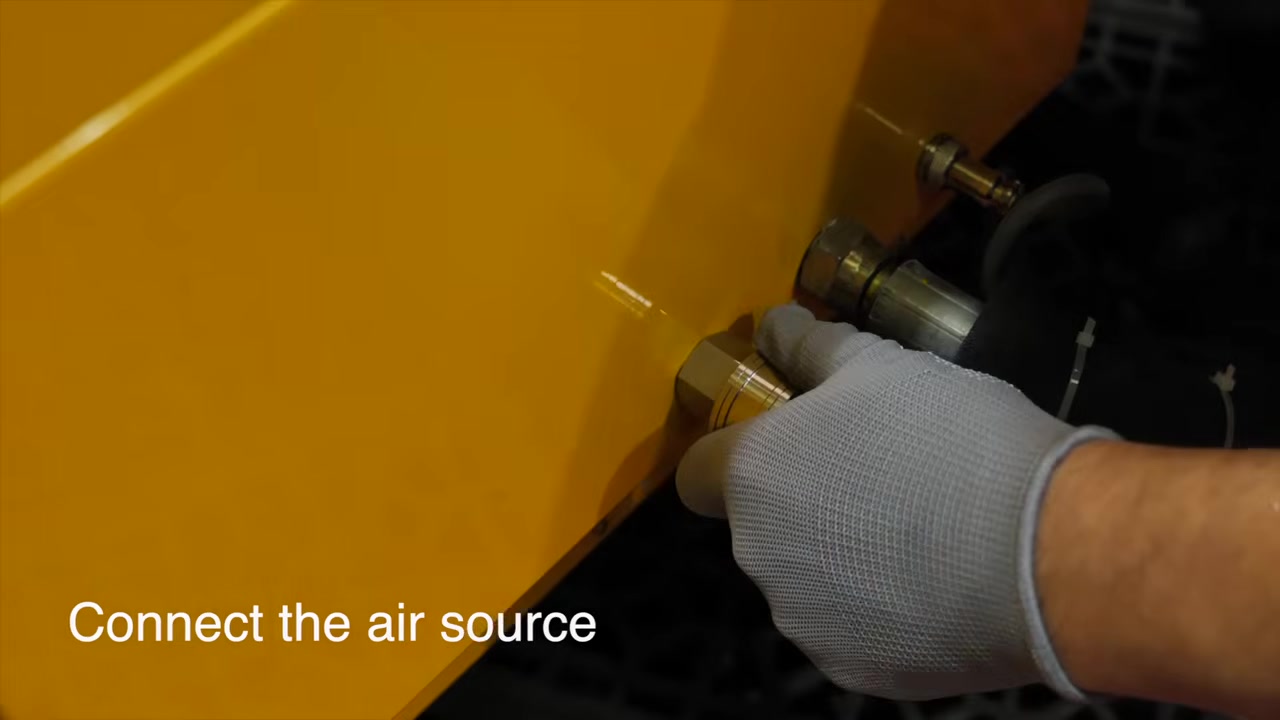 Technician connecting an external compressed-air hose to AUTOOL HTS708