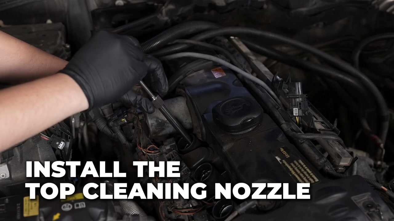 Technician positioning an AUTOOL HTS728 combustion-chamber cleaning nozzle