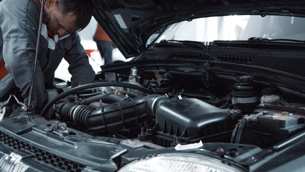 Technician carrying out a close vehicle inspection