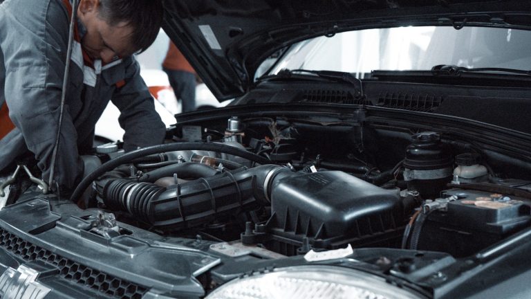 Technician carrying out a close vehicle inspection