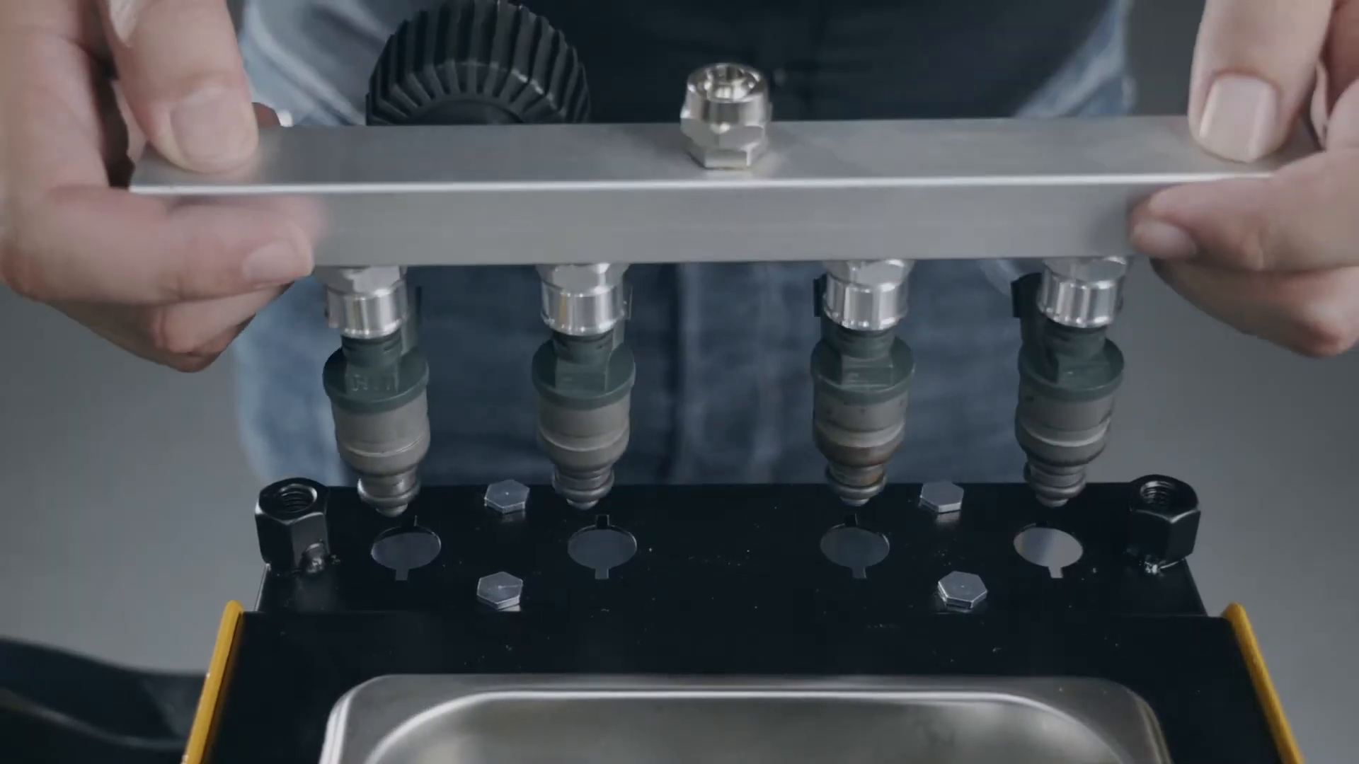 Four fuel injectors being seated under the CT150 test rail