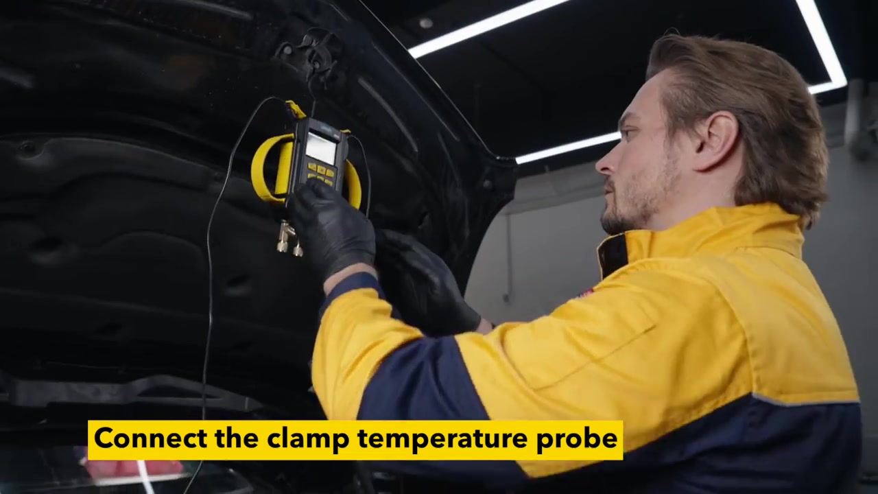 Technician hanging an AUTOOL LM160 while attaching a wired pipe temperature clamp