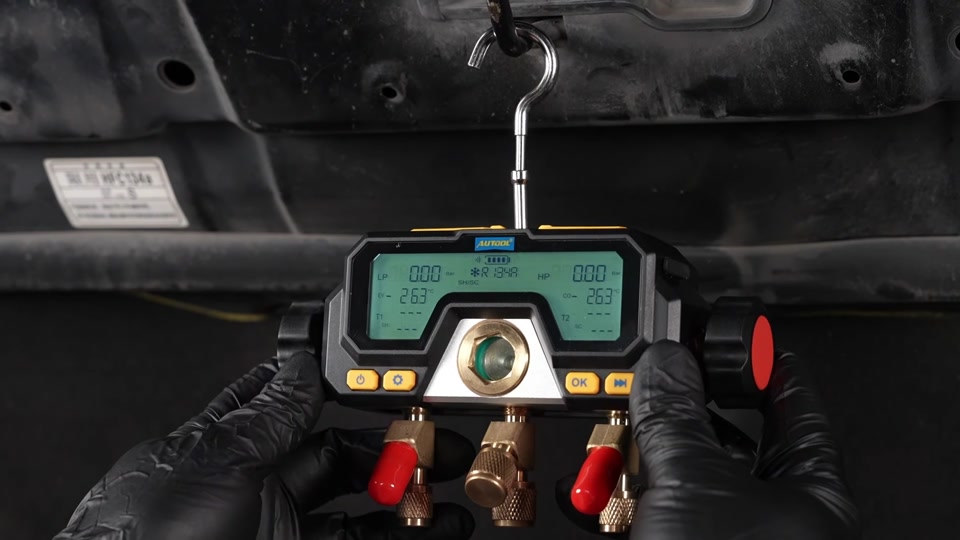 AUTOOL LM70 hanging upright above an engine bay with the display facing the technician