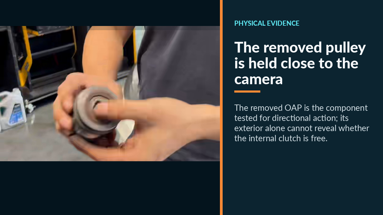 The removed pulley is held close to the camera