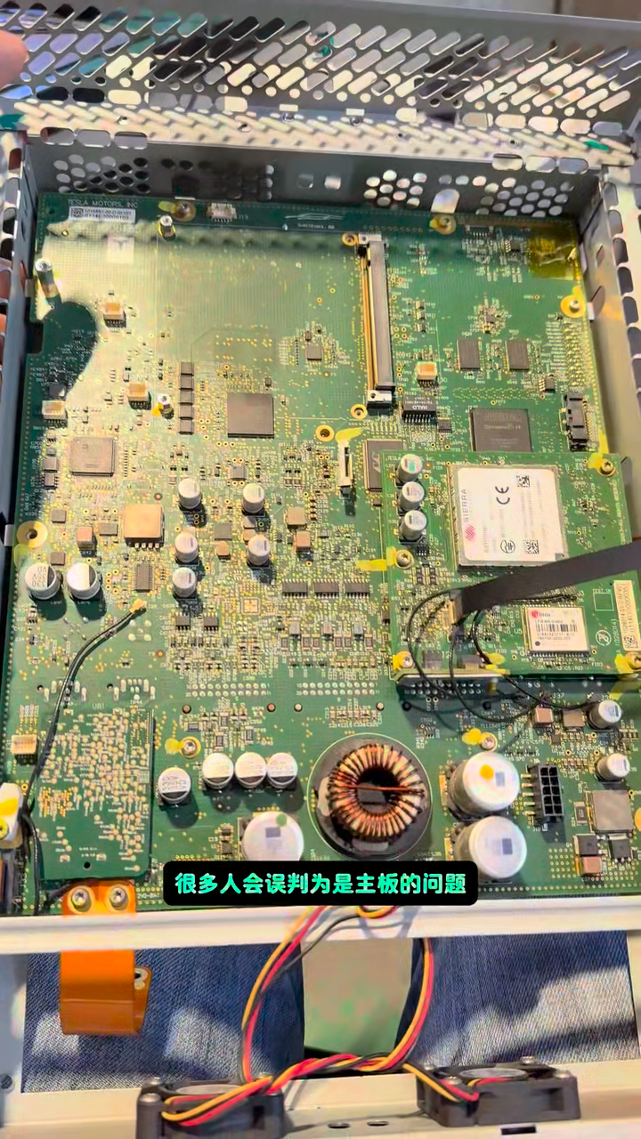 Opened Tesla Model S center assembly showing the MCU mainboard during display inspection.