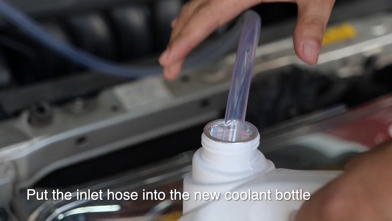 Official MRCARTOOL video frame showing the inlet hose submerged in a container of new coolant.