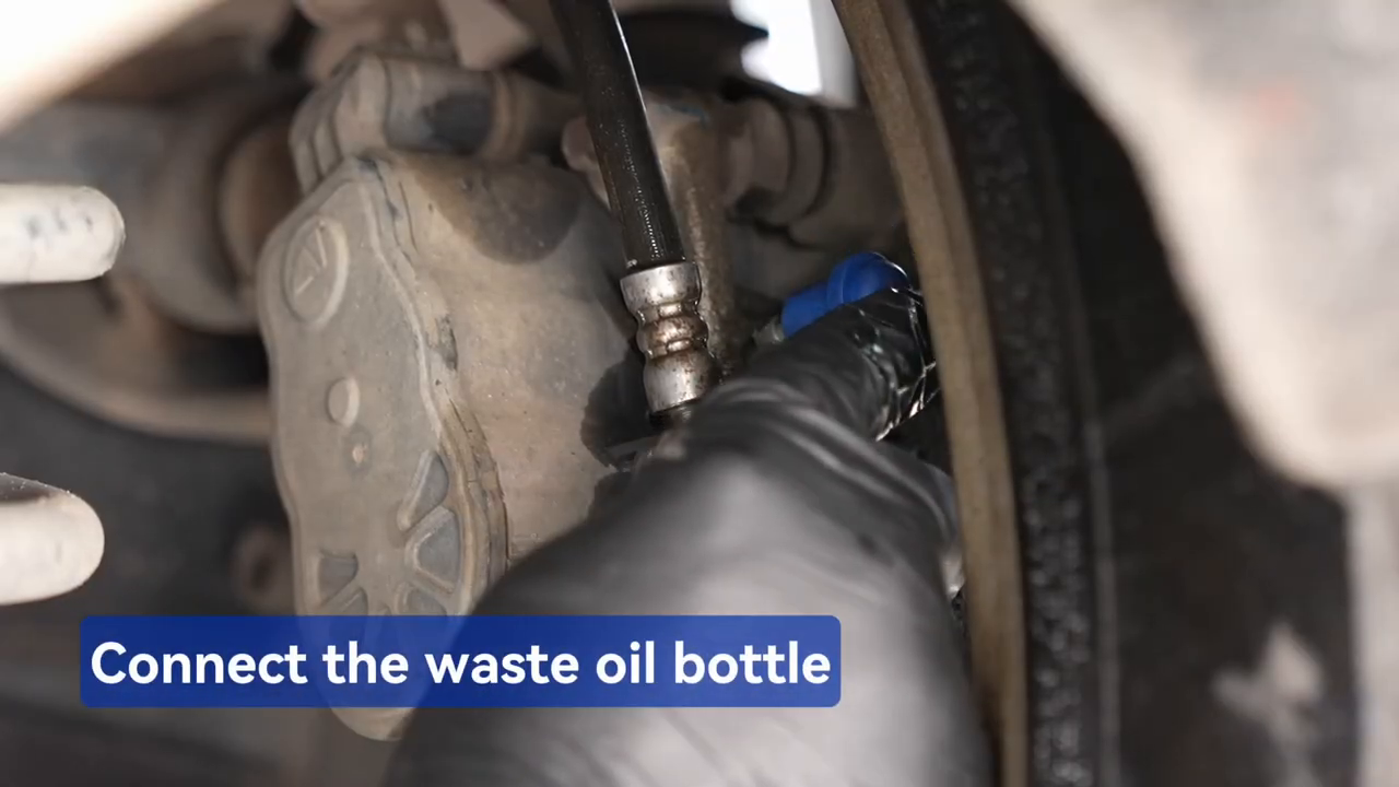 Official F109 tutorial frame showing the recovery bottle connected to a brake caliper bleeder.