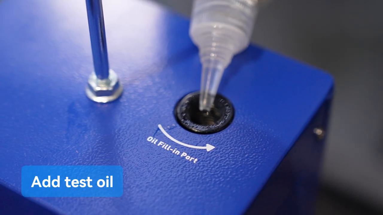Approved smoke-test oil being measured into the MRCARTOOL T105 oil-fill port.