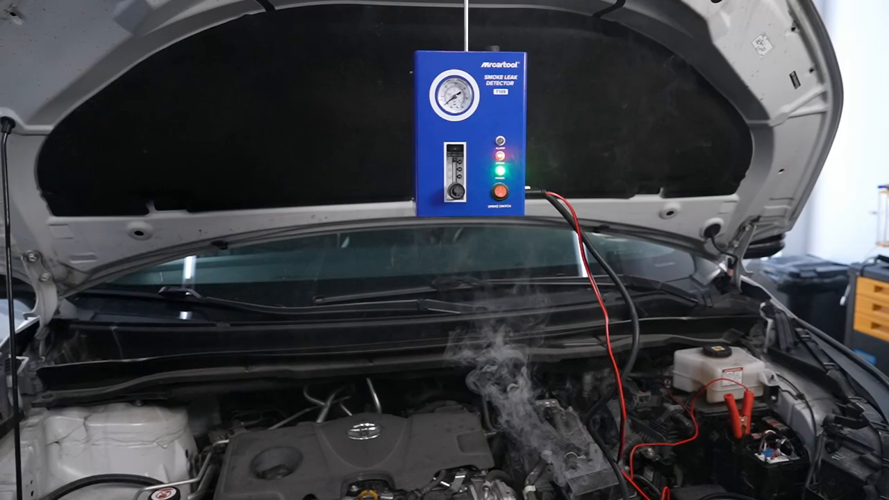 Visible smoke escaping from an automotive intake connection during a MRCARTOOL T105 test.