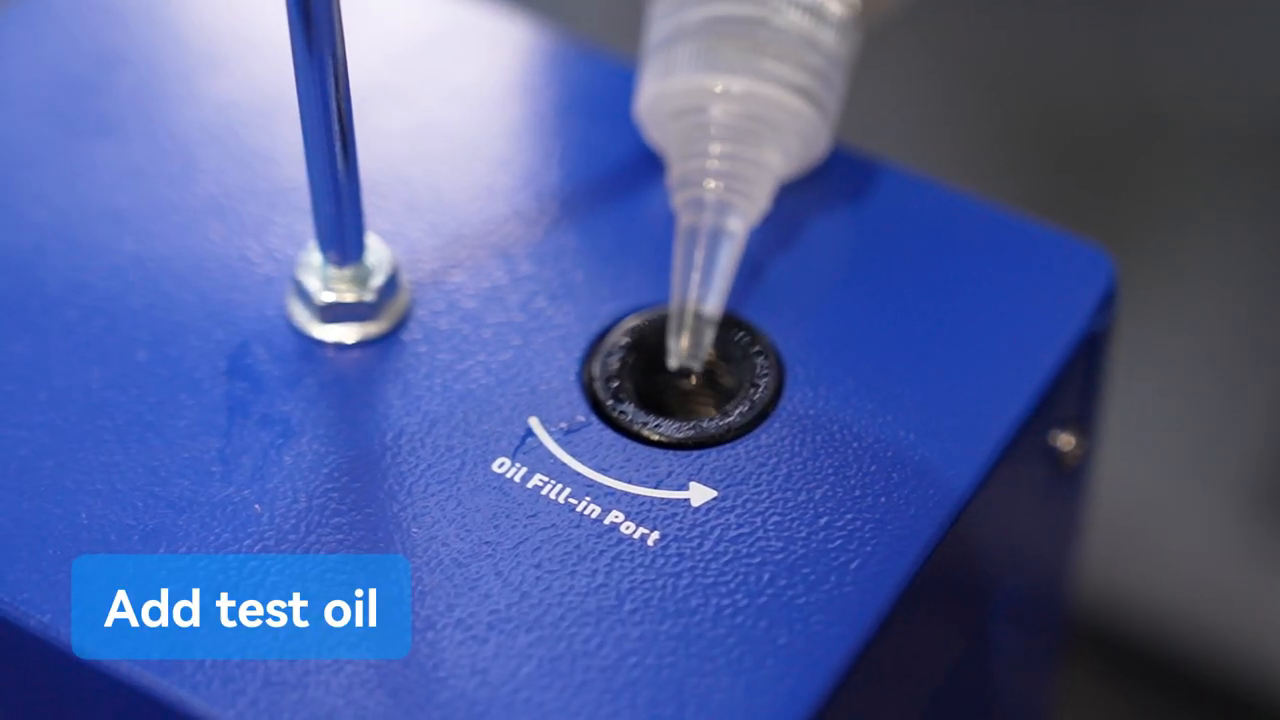 Approved smoke-test oil being measured into the MRCARTOOL T80 oil-fill port.
