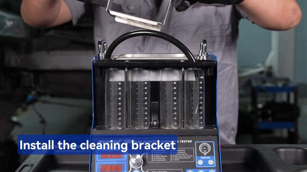 Technician placing the MRCARTOOL V209 cleaning bracket into the ultrasonic tank.