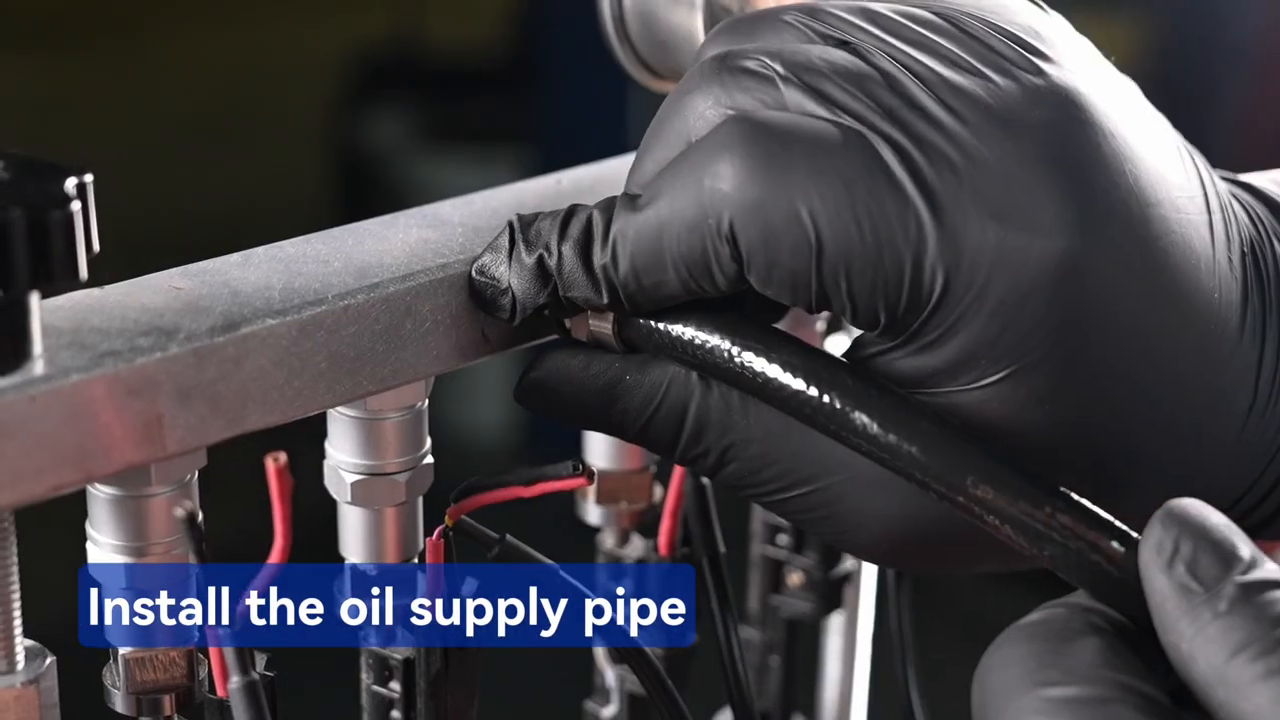 Technician connecting the MRCARTOOL V209 oil-supply hose after securing four injectors.