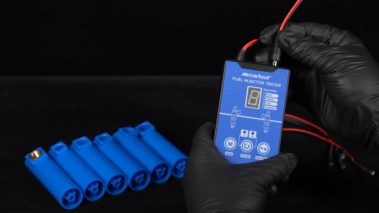 MRCARTOOL V30 powered from a 12-volt battery with red and black clips while the tester remains in standby.