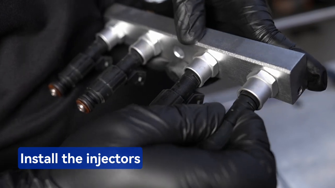 Technician installing four injectors into the MRCARTOOL V308 oil rail.