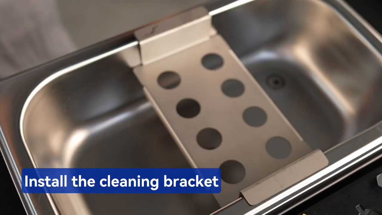 MRCARTOOL V310 ultrasonic cleaning bracket being placed flat in the tank.