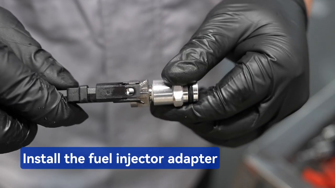 Technician fitting a metal MRCARTOOL V310 rail adapter to an injector.