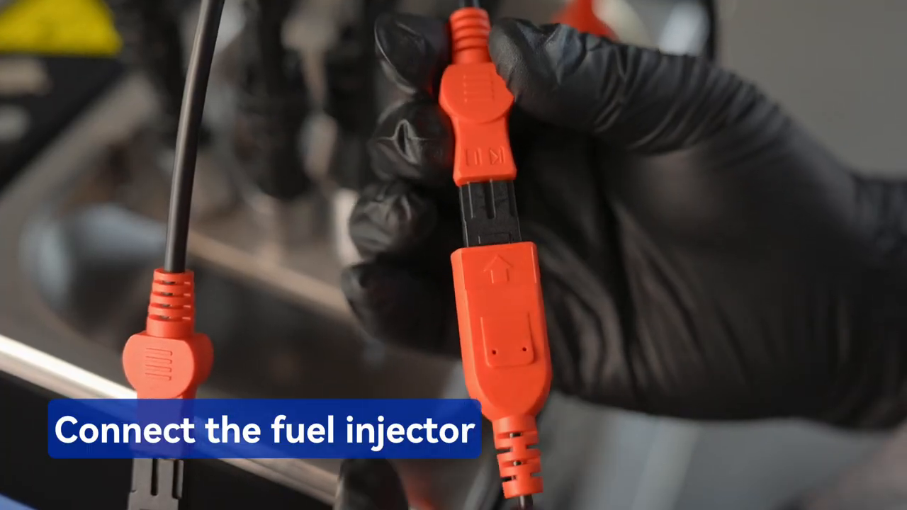 Technician connecting a MRCARTOOL V310 pulse lead to an injector before ultrasonic cleaning.