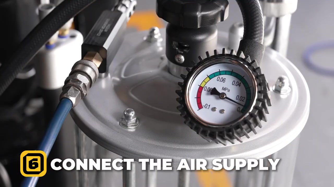Regulated shop air connected to the AUTOOL OD720 vacuum generator with the measuring-cup gauge visible