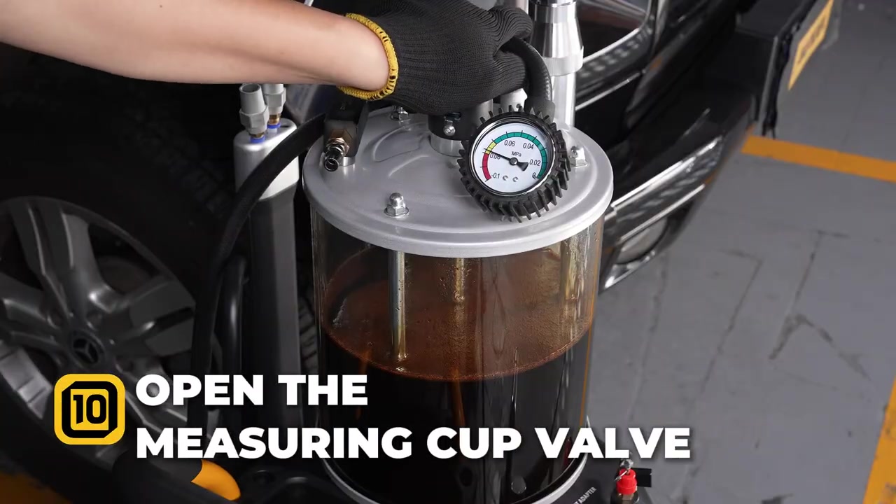 AUTOOL OD720 measuring-cup valve being opened to transfer collected oil into the storage tank