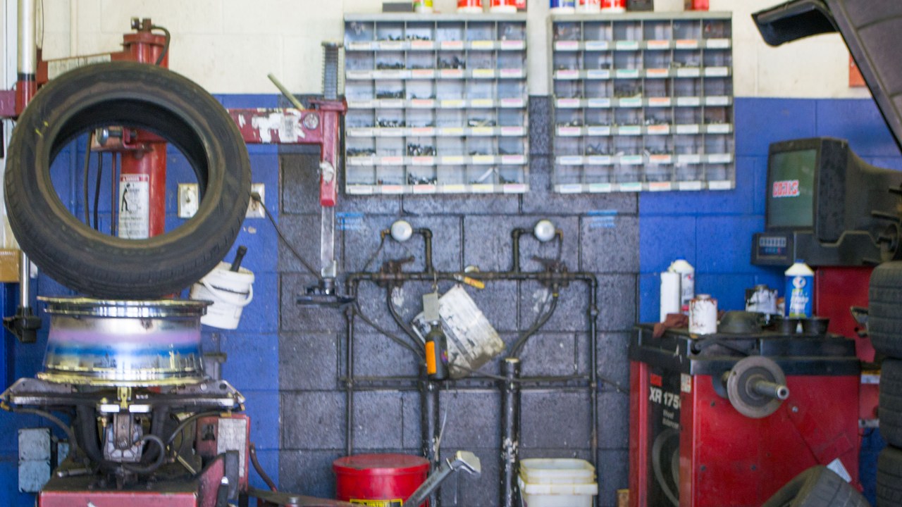 Tire shop with wheel-mounting and balancing equipment
