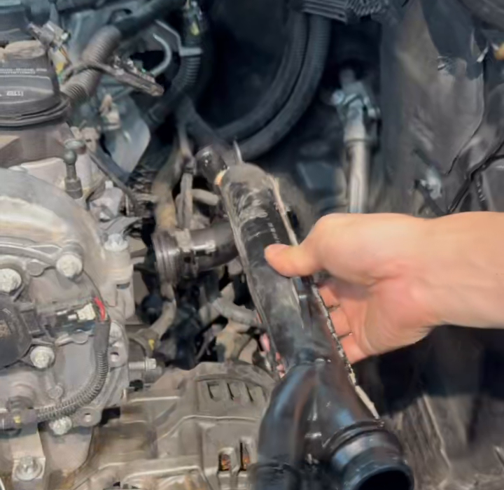 Removed polymer side pipe shown above the engine bay.