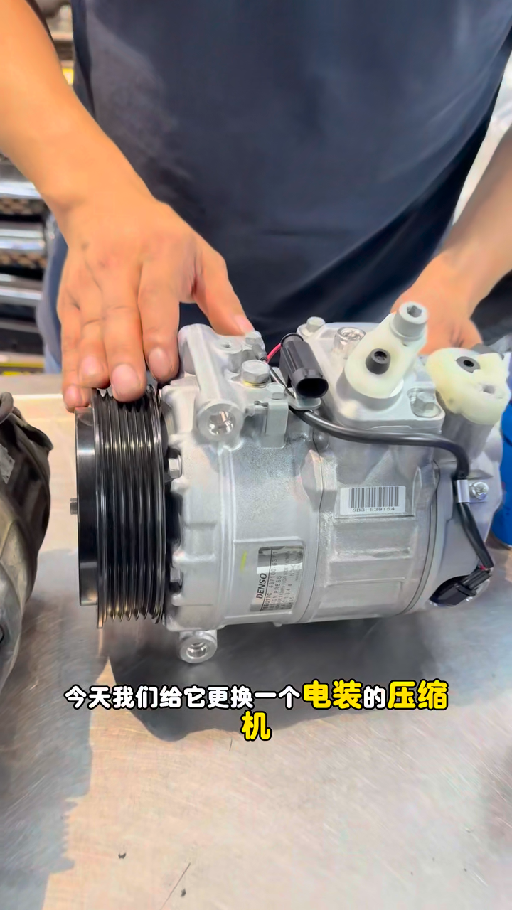 Replacement DENSO A/C compressor installed in the Mercedes engine bay.