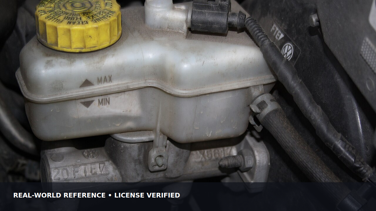 Brake fluid reservoir mounted in a passenger car engine bay