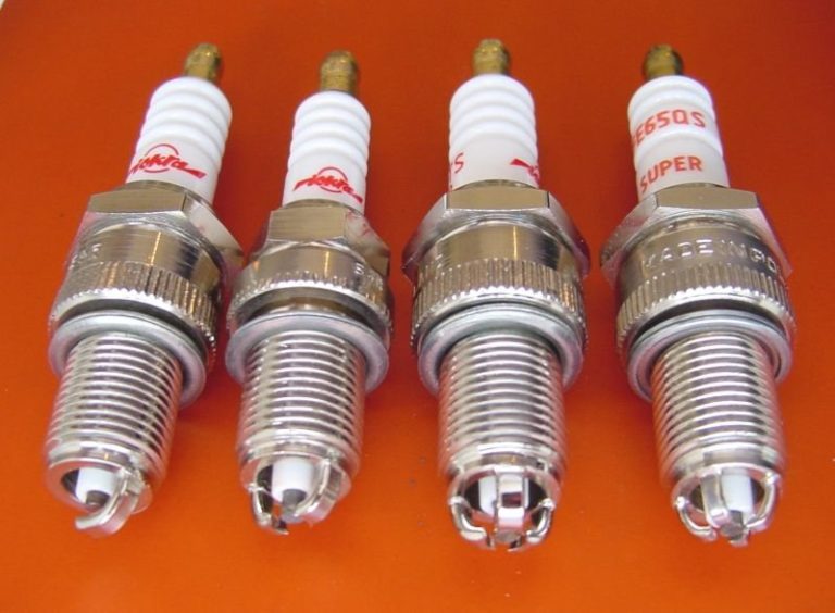 Four automotive spark plugs