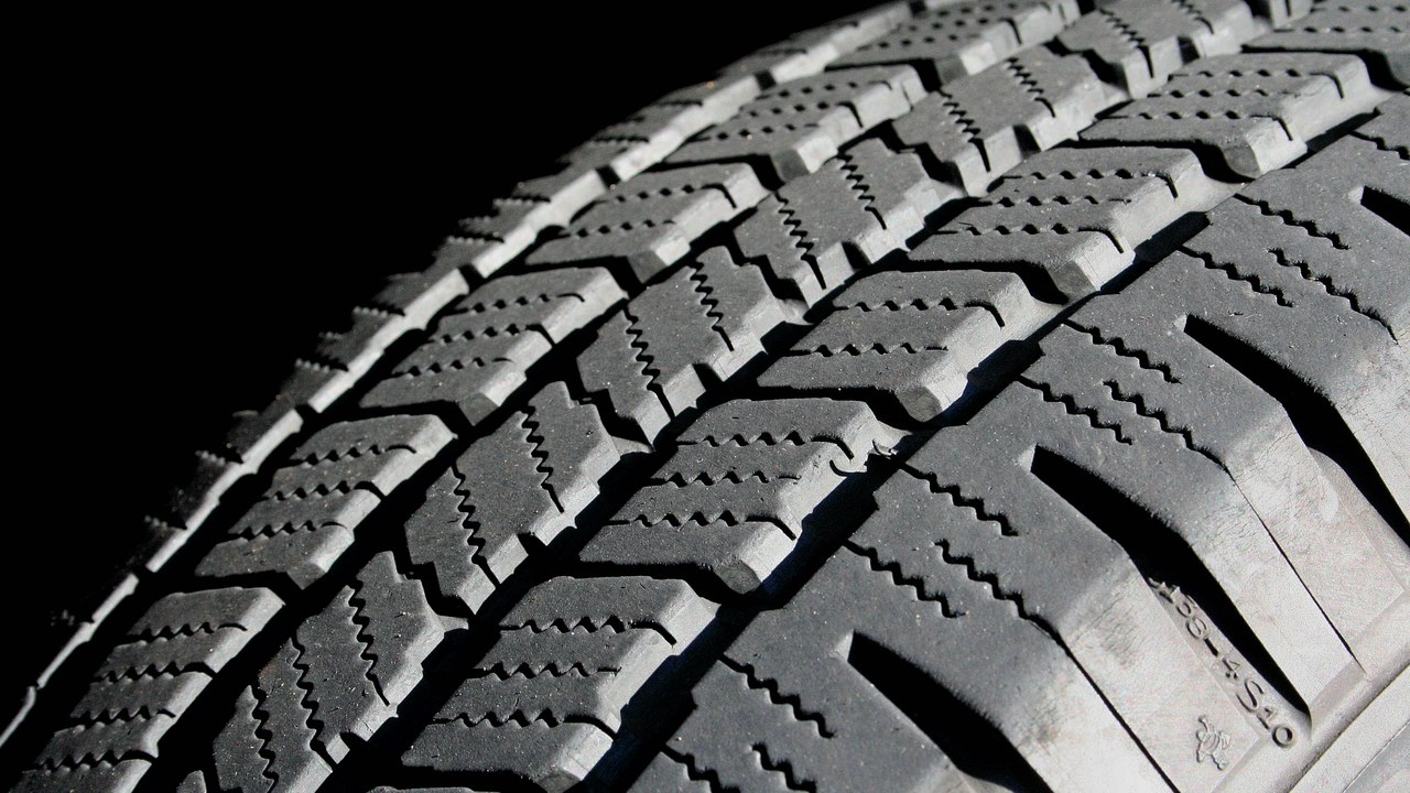 Close-up of passenger-car tire tread blocks and grooves